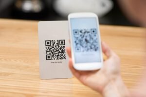 Closeup of a hand holding phone and scanning qr code. Woman hand